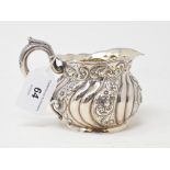 A Sterling silver milk jug, initialled to the underside, with embossed decoration, approx. 5.3 ozt