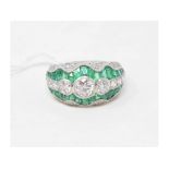 A platinum, emerald and diamond ring, set three graduated old cut diamonds, calibre cut emeralds and