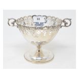 A silver pedestal bowl, with a pierced border and scroll handles, Birmingham 1929, approx. 11.4 ozt,
