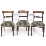 A set of six mahogany dining chairs, the horizontal crest rails carved enthium, on tapering turned