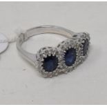 An 18ct white gold, triple oval cut sapphire and diamond cluster ring, the sapphires approx. 1.88ct,