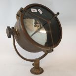 A spotlight, in a brass case, mounted in a frame, probably theatre related, 28.5 cm diameter Could