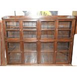 An oak bookcase, having an arrangement of four pairs of bar glazed doors, 151 cm wide