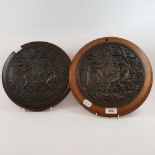 A late 19th century bronze roundel, Adam and Eve, on a mahogany panel, 29 cm diameter, and another