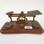 A set of late Victorian brass and oak postal scales, stamped S S Mordan and Co, £1 with engraved