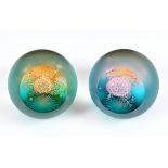 A pair of Caithness glass paperweights, Alpha & Omega set, designed by Colin Terris, limited edition