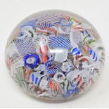 A baccarat scrambled glass paperweight, with various latticino and coloured glass canes, 6.2 cm