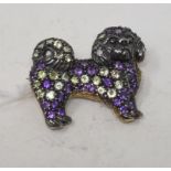 A 9ct gold, silver, amethyst and peridot dog brooch