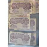 A collection of ten shillings and £1 banknotes, in an album