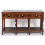 An oak dresser base, with three frieze drawers, on baluster turned supports joined by potboard base,