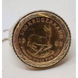 A South Africa 1/10 krugerrand, 1983, in a 9ct gold ring mount Report by RB Approx. 6.6 g