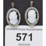 A pair of oval cameo earrings, within a surround of diamond chips, and a box Report by KB Good