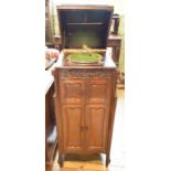 An early 20th century gramophone, in a mahogany cabinet, having two pairs of panel doors, 51 cm wide