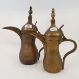 An Arabian brass dallah coffee pot, 31 cm high, and another similar (2)