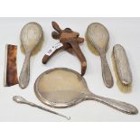 A silver backed part dressing table set, and a Black Forest style carved wood nutcracker in the form