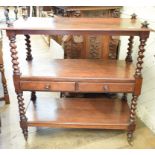 A Victorian mahogany three tier buffet, on barley twist supports, the central staged with two frieze