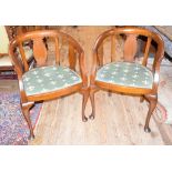 A pair of early 20th century mahogany tub armchairs, on cabriole front legs with pad feet (2)