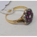 An 18ct gold, diamond and ruby flowerhead ring, approx. ring size R See inside back cover colour