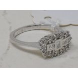 An 18ct white gold ring, set baguette and brilliant cut diamonds, approx. ring size O½