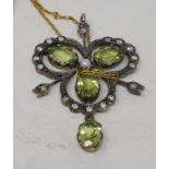 An Edwardian style pendant, set peridots, diamonds and a seed pearl, on a chain