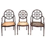 A set of ten George III style mahogany dining chairs, the circular backs carved bell flowers and