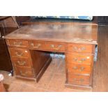 A mahogany pedestal desk, having an arrangement of nine drawers, 122 cm wide