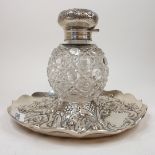 A Victorian silver and cut glass inkwell, embossed flowers and foliage, London 1891, approx. 5.3 ozt