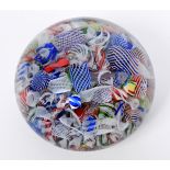 A baccarat scrambled glass paperweight, with various latticino and coloured glass canes, 6.2 cm