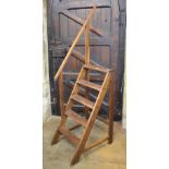 A pair of library oak steps, 48 cm wide Top part of grab rail has been repaired. Some worm to the