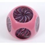 A Strathearn paperweight, with pink overlay circular cut windows, with inset cane inscribed S and