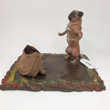 A painted bronze group, of a pug dog and a satchel, on a rug, 19.5 cm wide Modern