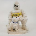 A painted iron figure, of the Michelin man and a dog, 20 cm high Modern