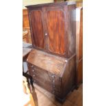 A 19th century mahogany bureau bookcase, having a pair of panel doors enclosing adjustable