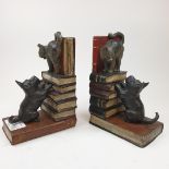 A pair of painted bronze bookends, in the form of a Scottie dog, a cat and books, 14 cm high Modern