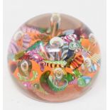 A Paul Ysart glass paperweight, the multi coloured scrambled ground with inset air bubbles, 7 cm