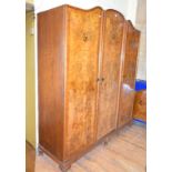 A 1920's inlaid burr walnut three door wardrobe, 183 cm wide, two pairs of single bed ends, and a