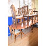 A Regency style mahogany twin pillar dining table, crossbanded in satinwood and with boxwood and