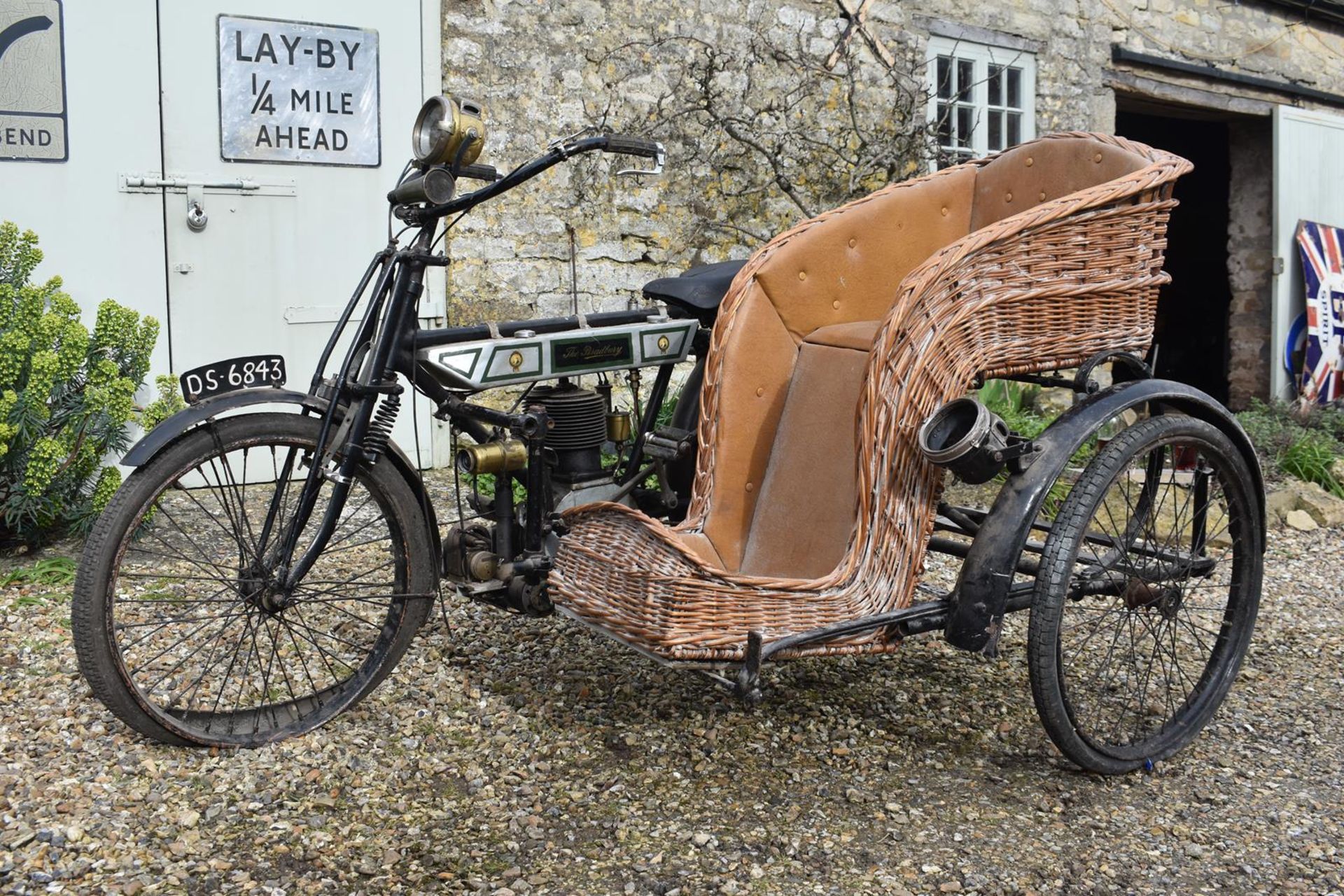 A 1911 Bradbury De Luxe Flat Tank Combination Registration number DS 6843 Wicker single chair