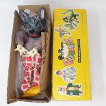 A Pelham puppet, SL Wolf, in a yellow box lid
