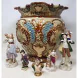 An Edwardian pottery jardiniere, restored, 35 cm high, various porcelain figures and other items (