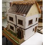 A doll's house, Claypit Farm, in the style of a 17th century thatched dwelling, 63 cm wide, with