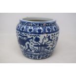 A Chinese pottery jardiniere, decorated fish and foliage in underglaze blue, 17.5 cm high firing