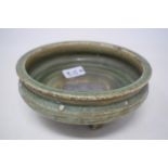 A Chinese green crackle glazed Song dynasty style pottery bowl, with incised decoration, on three