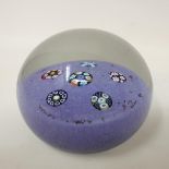 A Paul Ysart glass paperweight, the purple ground decorated with six groups of coloured canes, 7.5
