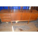 A G-Plan style teak sideboard, 183 cm wide, and a similar dining table, with a pop out section,