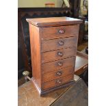 A Victorian mahogany miniature table top chest, of six drawers, on a plinth base, 24 cm wide