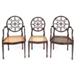 A set of ten George III style mahogany dining chairs, the circular backs carved bell flowers and