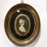 A bust portrait of a lady, wearing feathers in her hair, in high relief, in an oval frame Please