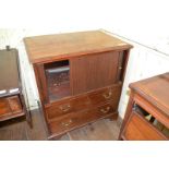 A 19th century mahogany bedside cupboard, with a tambour front above two drawers, 75 cm wide