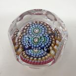 A Whitefriars Millefiore glass paperweight, with faceted sides and cane dated 1972